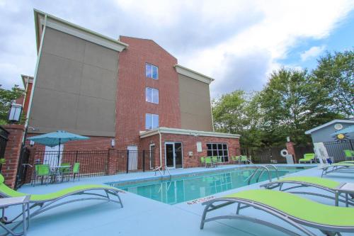 a swimming pool in front of a building at Holiday Inn Express Hotel & Suites Charleston - North by IHG in Charleston