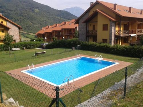 a swimming pool in front of a house at Chalet Rural El Encanto in Ojedo