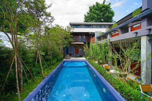 a swimming pool in the yard of a house at Yellow Pillow village in Chiang Mai