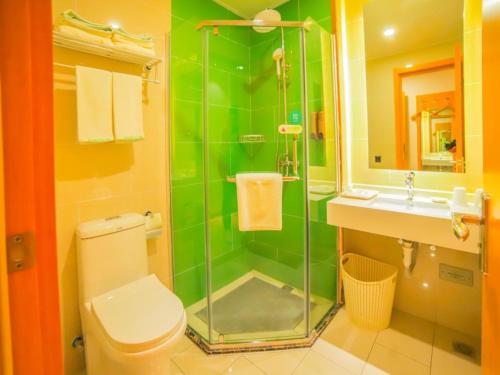 a bathroom with a shower and a toilet and a sink at GreenTree Inn Beijing Shunyi District Fuqian West Street Shimen Subway Station Express Hotel in Beijing