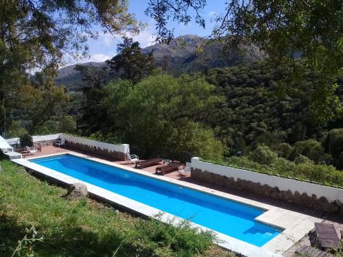 a swimming pool in front of a mountain at Boutique Hotel Sevilla in La Cumbre