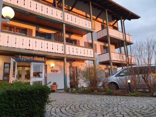 a building with a car parked in front of it at Apparthotel Garni Superior Simsseeblick in Bad Endorf