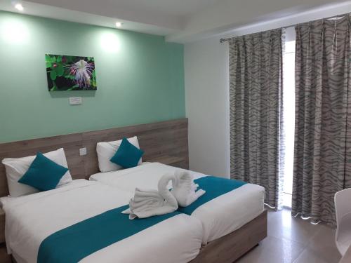 a bedroom with a bed with a towel on it at TJ Boutique in Marsaskala