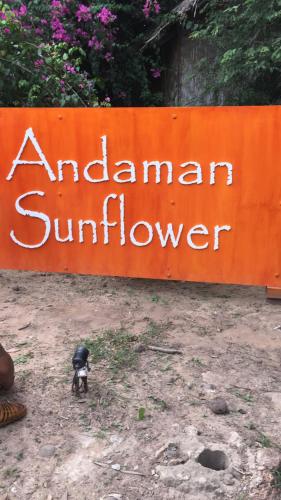 a small figurine standing in front of an american sunflower sign at Andaman Sunflower in Ko Lanta