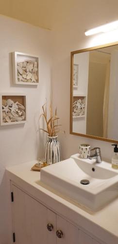 a bathroom with a white sink and a mirror at Comporta House in Comporta