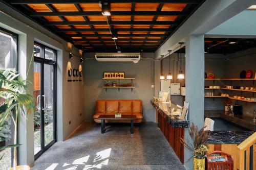 an office with an orange couch in a room at Yellow Pillow village in Chiang Mai