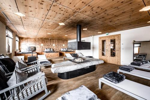 a living room with a couch and a table at Hotel Edelweiss & Gurgl in Obergurgl