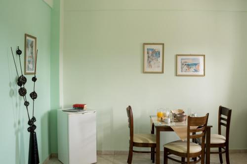 a dining room with a table and chairs at Moonlight Apartments & Suites in Fira