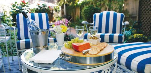 a table with a plate of food and glasses of wine at Morgan State House Inn in Albany
