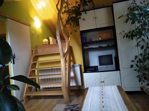 a living room with a spiral staircase in a house at Pod Kornutami in Sękowa