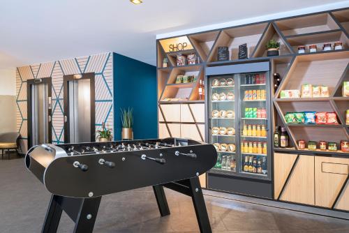 a store with a ping pong table in a room at Aparthotel Adagio Paris Montrouge in Montrouge