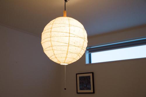 a light fixture hanging from a ceiling in a room at Riverside Yofuke AFP Villa in Nago