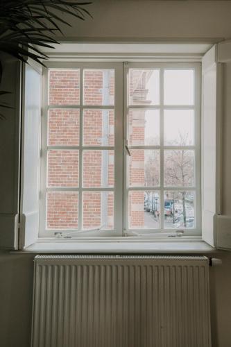 a window with a radiator in front of a brick building at Brass Hotel in Utrecht