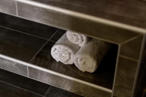 two rolls of towels sitting on a shelf at Moonlight Apartments & Suites in Fira