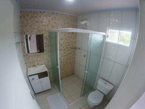 a bathroom with a shower and a toilet at Pousada Graff in Penha