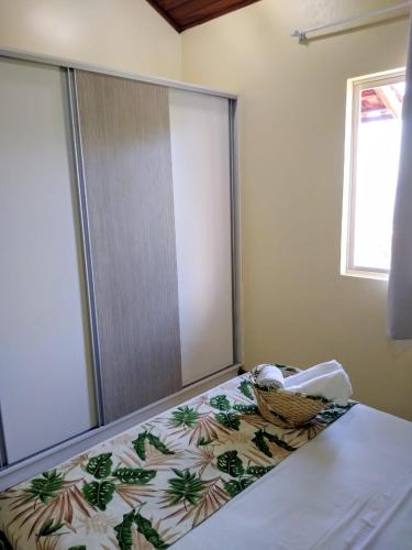 a bedroom with a bed with a blanket on it at Pousada Vó Regina in Florianópolis