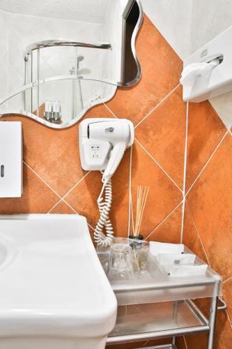 a bathroom with a hair dryer on a wall at Грибова хата in Bukovel