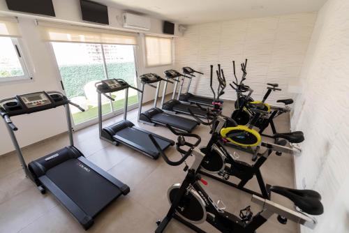 a row of exercise bikes in a fitness room at Ker San Telmo Hotel in Buenos Aires