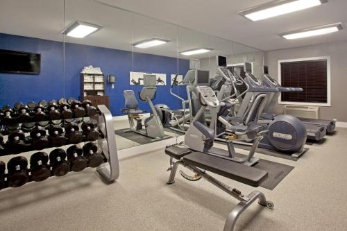 a gym with several treadmills and weights at Holiday Inn Express Hotel & Suites Minneapolis - Minnetonka by IHG in Minnetonka