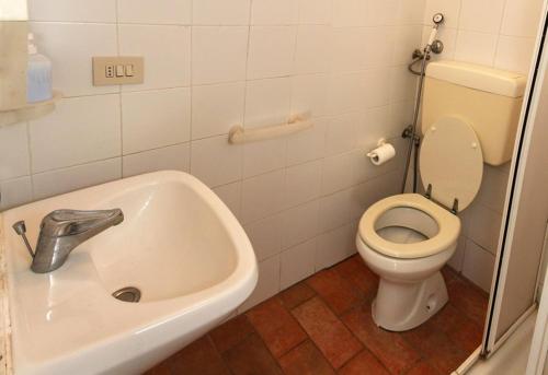 a bathroom with a sink and a toilet at room in farmhouse near san gimignano in San Gimignano