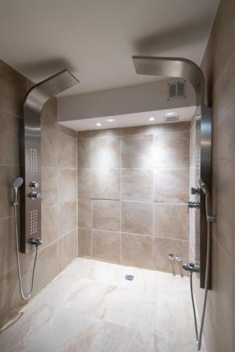 a shower stall in a bathroom with a tile floor at Ker San Telmo Hotel in Buenos Aires