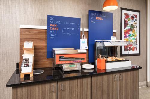 a kitchen with a cash register on a counter at Holiday Inn Express Hotel & Suites Minneapolis - Minnetonka by IHG in Minnetonka