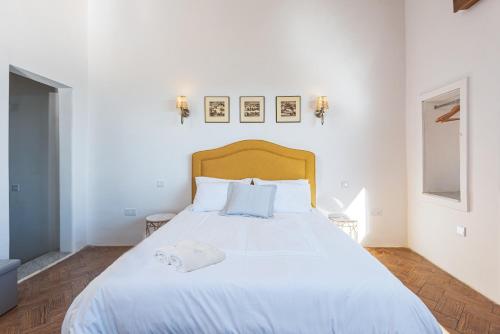 a bedroom with a large white bed with two pillows at Harbour Heights in Valletta