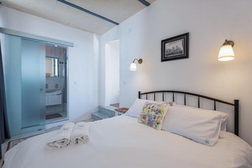 a bedroom with a bed with two towels on it at Harbour Heights in Valletta
