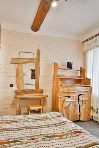 a bedroom with a bed and a table and a mirror at Грибова хата in Bukovel