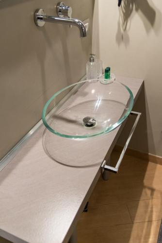 a bathroom sink with a glass counter top at Residenza Ca' degli Enzi in Verona