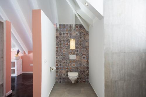 a bathroom with a toilet in the middle of a room at BOHO Bohemian Boutique Hotel in Willemstad