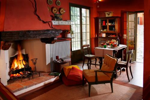 a living room with a fireplace and a table and chairs at I Veroni - Agriturismo and Wine Cellar in Pontassieve