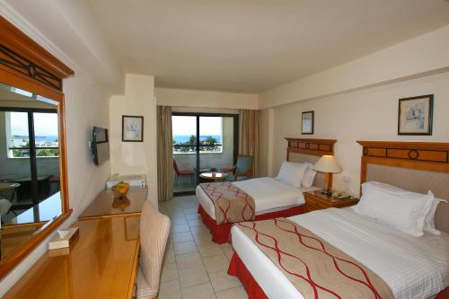 Postel nebo postele na pokoji v ubytování Mina Hotel