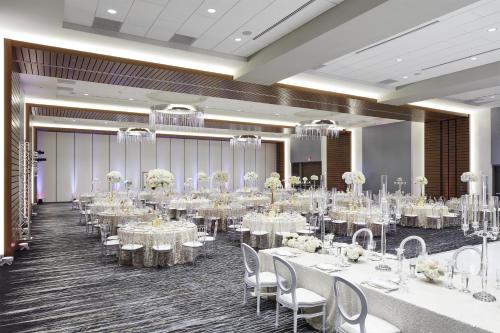 a banquet hall with white tables and chairs at InterContinental Minneapolis - St. Paul Airport by IHG in Minneapolis