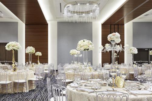 a banquet hall with white tables and chairs at InterContinental Minneapolis - St. Paul Airport by IHG in Minneapolis