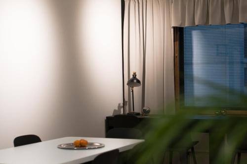 a plate of fruit on a table in a room at Aikatalo Hostel Helsinki in Helsinki