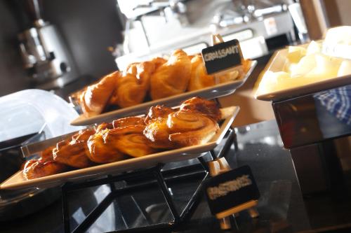 two trays of pastries on display in a bakery at Best Western Garfield House Hotel in Chryston