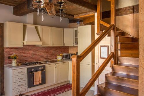 eine Küche mit weißen Schränken und eine Treppe in einem Haus in der Unterkunft Vigna Della Signora in Morano Calabro