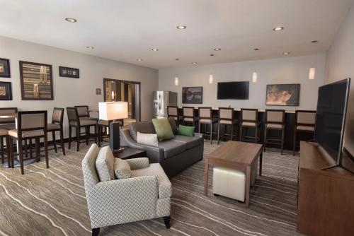 a waiting room with furniture and a flat screen tv at Staybridge Suites - Wisconsin Dells - Lake Delton by IHG in Wisconsin Dells
