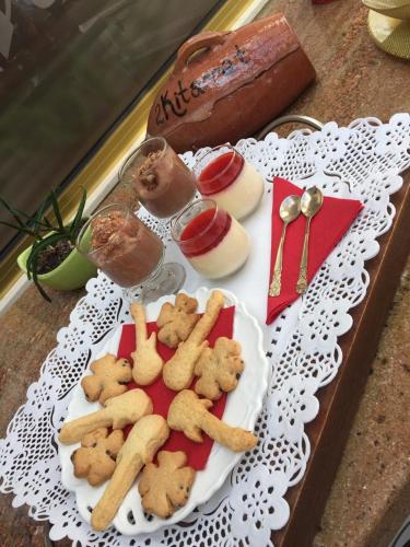 a plate of food with cookies on a table at 2 KITARRAT Boutique Hotel & SPA in Durrës