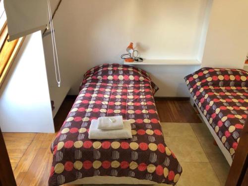 a bedroom with a bed with a blanket on it at Roosevelt in Buenos Aires