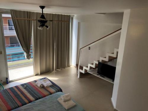 a bedroom with a bed and a large window at Roosevelt in Buenos Aires