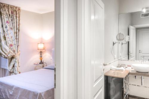 a bathroom with a bed and a sink at Right House di Via Sulis - Best Neighborhood in the Town in Cagliari