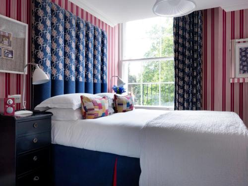 a bedroom with a bed and a window at Dorset Square Hotel, Firmdale Hotels in London