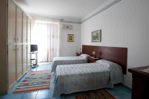 מיטה או מיטות בחדר ב-Residence Il Capo