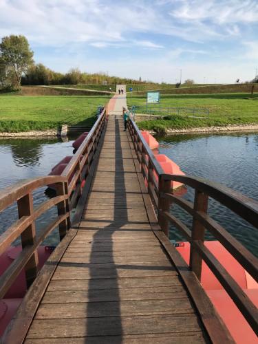 a wooden bridge over a body of water at EVA Rooms & Studio Apartment in Karlovac