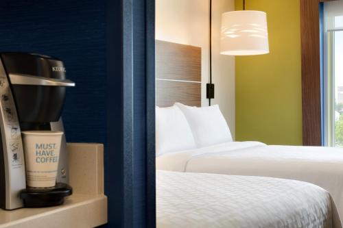 a hotel room with two beds and a coffee maker at Holiday Inn Express & Suites Brunswick-Harpers Ferry Area by IHG in Brunswick