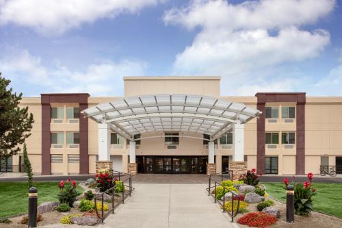a large building with a retractable arch in front at Holiday Inn Missoula Downtown by IHG in Missoula