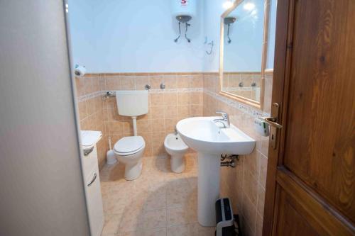 a bathroom with a toilet and a sink at Residence Il Capo in Palermo