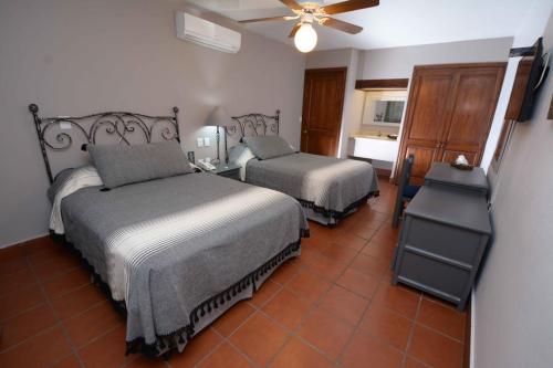 Cama o camas de una habitación en Hotel Hacienda